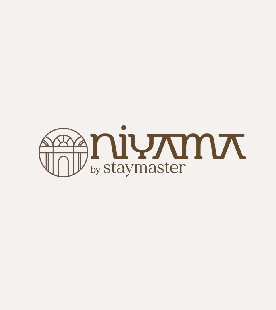 Niyama by Staymaster logo in brown on cream